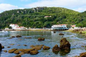 a river with rocks in front of a mountain at Traditional Portuguese House in Setúbal