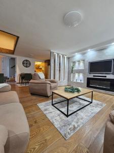 a living room with a couch and a coffee table at Museum Apartment in Subotica
