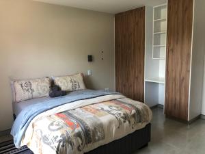 a bedroom with a large bed with a wooden closet at F2 Homestead in Omuthiya