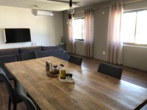 a conference room with a wooden table and chairs at F2 Homestead in Omuthiya