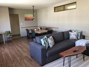 a living room with a couch and a table at F2 Homestead in Omuthiya