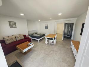 a living room with a couch and a table at Apartments Pronavtik in Piran