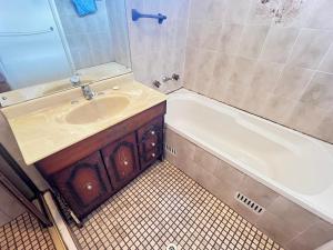a bathroom with a sink and a bath tub at Room 53 in Sydney