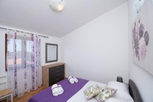 a bedroom with a bed with two towels on it at Apartmani Selo Luka in Ražanj +35 photos