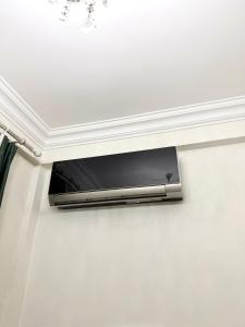 a flat screen tv hanging on a wall at Nice Apartment in the City Center in Yerevan