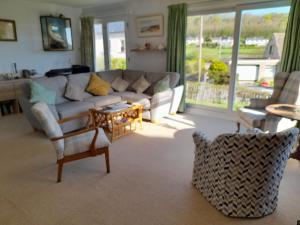 a living room with a couch and a table at Coldstream Cottage in Dale