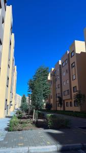 an empty street in a city with buildings at Exclusive Modern Garden Flat ,Marrakech in Marrakesh
