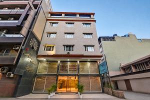 a building with a store front in a city at Hotel Mayur in New Delhi