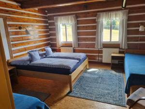 a bedroom with two beds in a log cabin at Penzion Bouda Na stráni in Dolní Malá Úpa