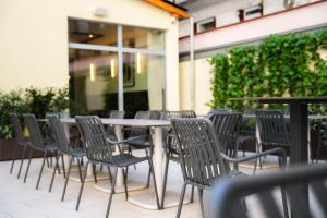 a group of chairs around a table in a patio at Honest Budapest by chic&basic in Budapest
