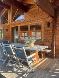 a wooden cabin with a wooden table and chairs at Chalet Cosy in Bramberg am Wildkogel