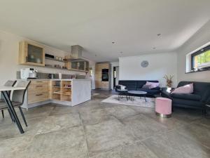 a living room and kitchen with a couch and a table at Ferienhaus am Lanzer See in Lanze