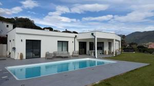 a house with a swimming pool in the yard at villa la baies des anges in Calcatoggio