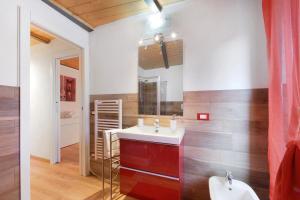 a bathroom with a sink and a mirror at Prima Del Cielo - Alba Apartment in Perledo +21 photos