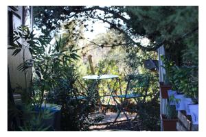 a patio with a table and a chair in a garden at La caravane plage in Pietroso