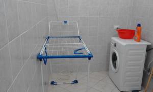 a bathroom with a toilet with a shelf on it at AmareViaggiareLowcost in Manduria