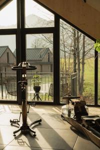 a room with a large window with chairs and a table at Agrad Chalets in Aschau im Chiemgau