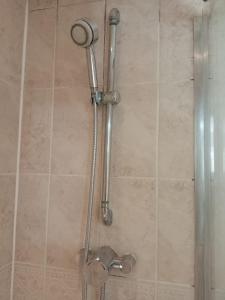 a shower with a shower head in a bathroom at 2 Bedrooms Flat in Surrey, 30 min to London in Woking