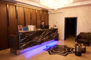a man standing at a counter in a lobby at Mari Suites Hotel in Istanbul