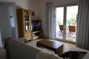 a living room with a couch and a sliding glass door at Villa Pilias Methoni in Methoni