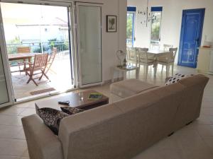 a living room with a couch and a table at Villa Pilias Methoni in Methoni +32 photos