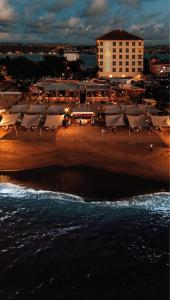 a view of a beach with a hotel and the ocean at Almar Aparthotel in Lobito