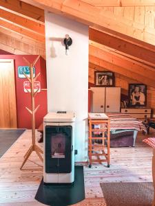 a living room with a stove and a bedroom at Mansarda Il Castello in Ossana