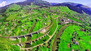 an aerial view of a village on a green hill at Котедж - Prestige in Vorokhta