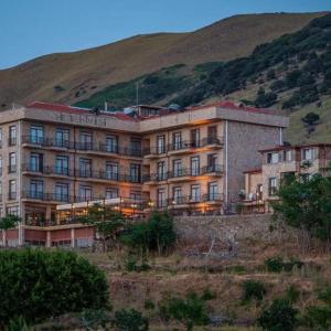 a large building on the side of a hill at Masi Otel in Bademli