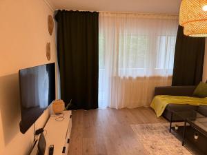 a living room with a flat screen tv and a couch at Schönes Apartment in Top-Lage Karlsruhe in Karlsruhe
