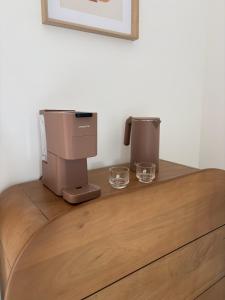 a coffee machine sitting on top of a wooden dresser at Chambre d'hôtes Lilas in Saint-Lyphard
