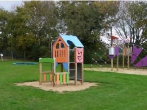 a group of playground equipment in a park at Mobil-home cosy avec terrasse et jardin privatif in La Bernerie-en-Retz