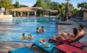 a group of people in the swimming pool at a resort at Mobil-home cosy avec terrasse et jardin privatif in La Bernerie-en-Retz