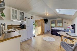 a kitchen and living room with a table and a bed at Landhaus Melch in Zwiesel