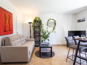 a living room with a couch and a table at Gite Paul Sallou in Perros-Guirec