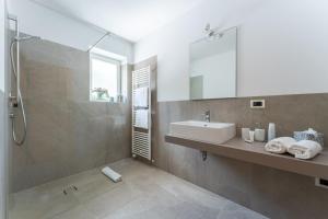 a bathroom with a sink and a shower at Ferienappartement Freiblick in Marlengo +35 photos