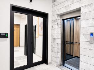 a pair of glass doors in a building at Ixoras Hotel Lemba in Kinshasa +43 photos