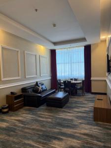 a living room with a couch and a table at Karam Al Balad Hotel in Jeddah