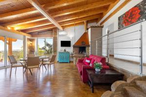 a living room with a red couch and a table at Villa Luisana con Piscina e Vista in Sonnino