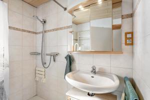 a bathroom with a sink and a shower at Apartment Burgquartier in Schmallenberg +21 photos