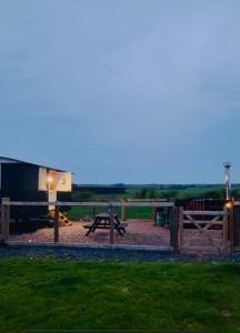 a park with a picnic table and a playground at Coorie and Keek Shepherd's Hut in Prestrie
