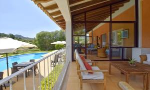 a balcony of a house with a swimming pool at Sa Font den Ros Mallorca in Son Servera