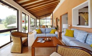 a living room with a couch and a table at Sa Font den Ros Mallorca in Son Servera