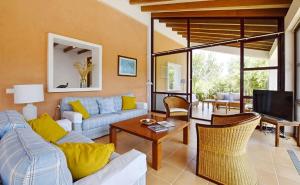 a living room with a couch and a tv at Sa Font den Ros Mallorca in Son Servera