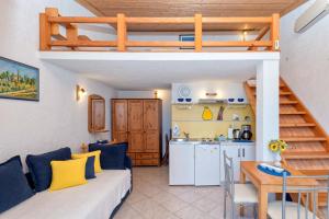 a living room with a loft bed and a kitchen at Apartments Perić in Jelsa