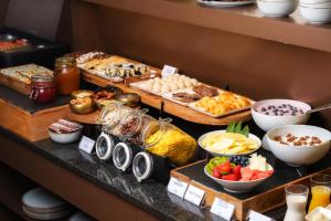 a buffet with many different types of food on a table at Honest Budapest by chic&basic in Budapest +68 photos