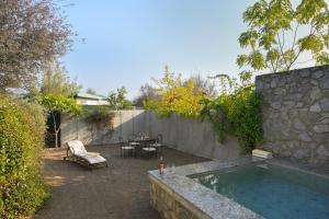a backyard with a swimming pool and a table and chairs at Trulyy The Jawai Leopard Kingdom in Jāmb +19 photos