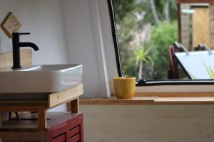 a kitchen with a sink and a window at La caravane plage in Pietroso