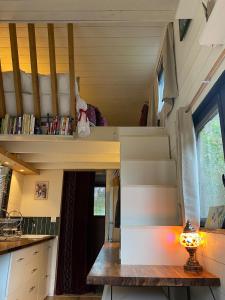a tiny house with a staircase in a kitchen at Tiny House de Clara in Avrillé