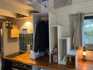 a room with a kitchen with a counter and a shelf at Tiny House de Clara in Avrillé +23 photos